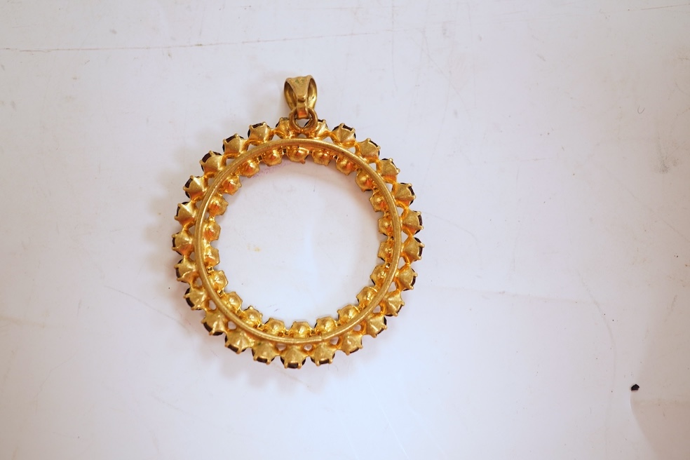 Two necklaces, comprising: a three-strand cultured pearl necklace, to a cabochon garnet and diamond clasp, length 34cm; and a paste and gilt metal pendant on a gold chain, chain length 44cm, stamped 14K, gross weight of